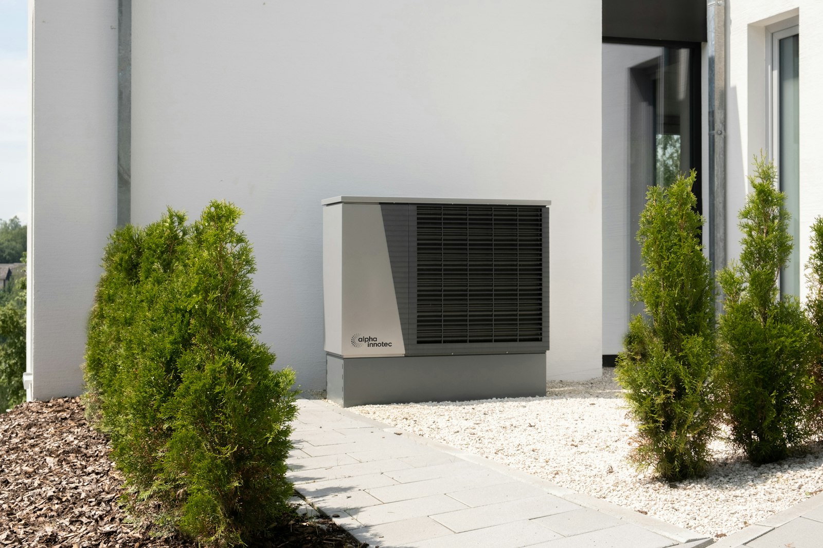 A residential HVAC unit beside a modern home exterior. The systems most expensive to replace are the cheapest to maintain.