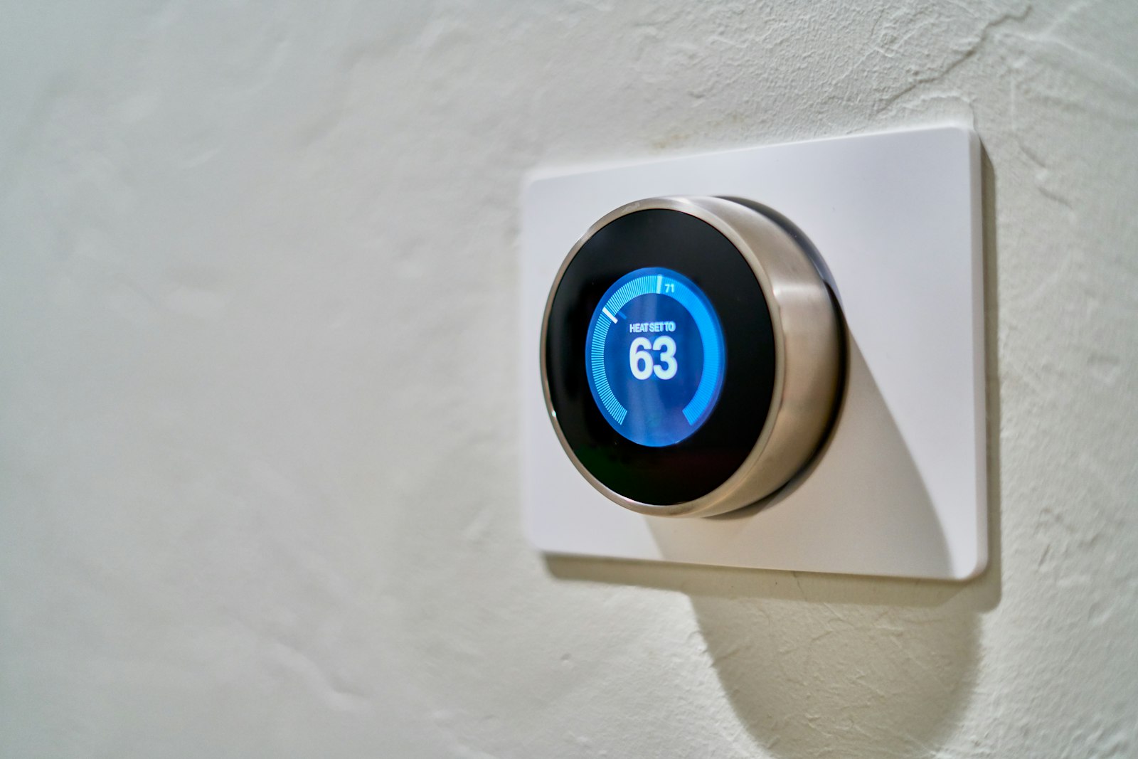 A modern Nest smart thermostat mounted on a residential wall — the kind of HVAC control system every North Texas homeowner should verify before summer.