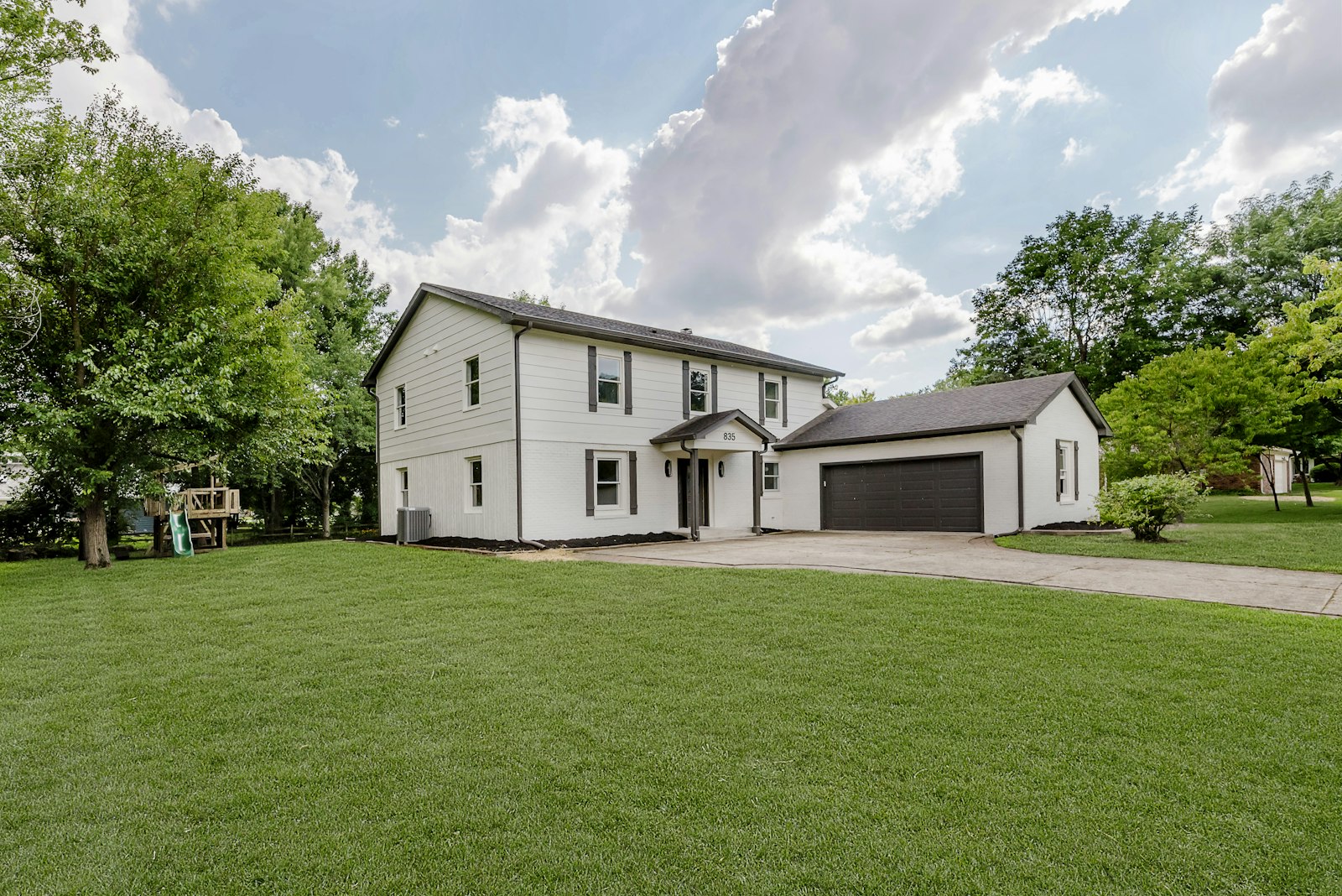 A modern suburban North Texas home with manicured lawn and mature trees — representative of new builds across Celina, Light Farms, Mustang Lakes, Cambridge Crossing.