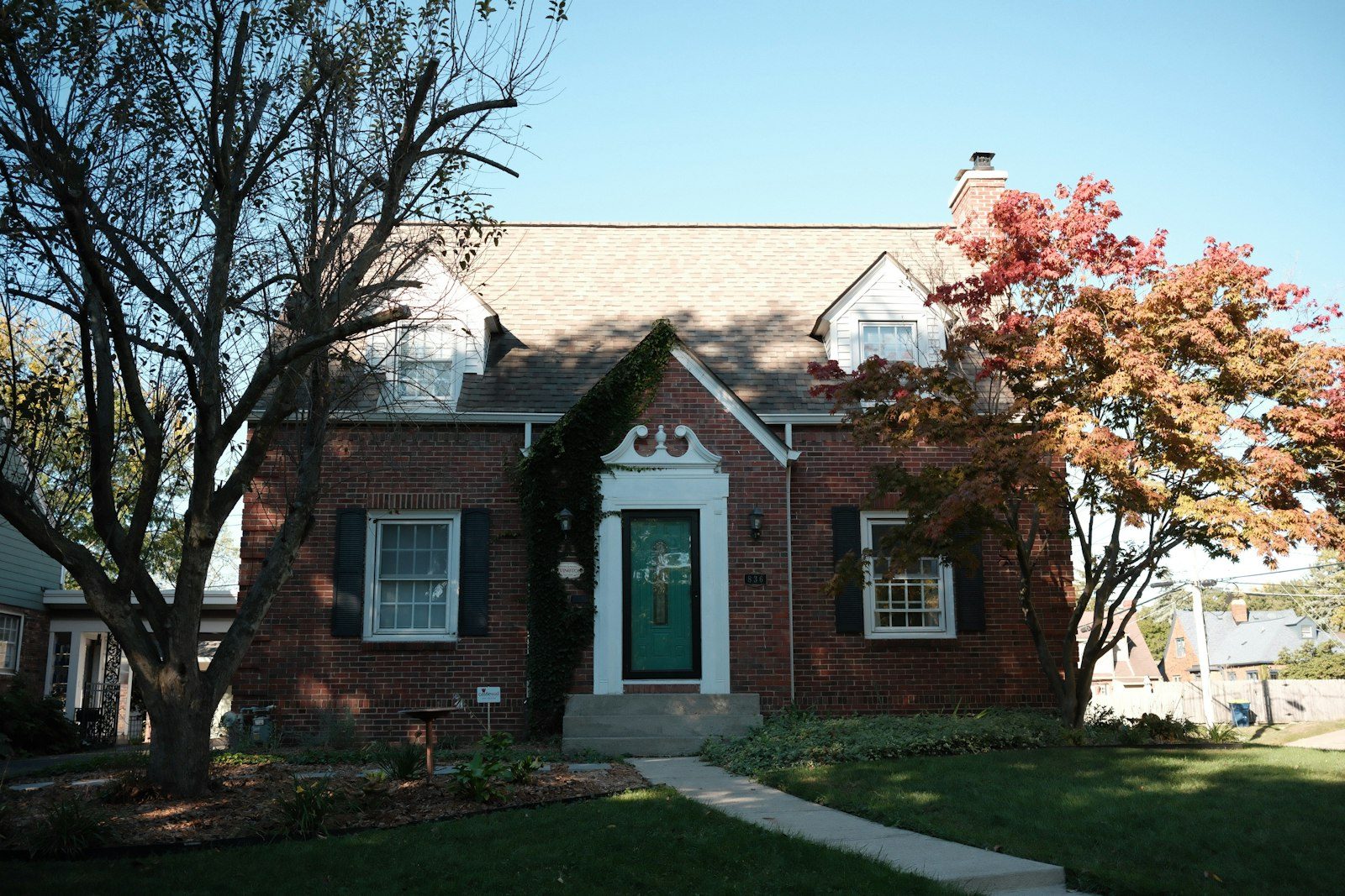 A brick home with strong curb appeal and a tidy front walkway, prepared to go on the market