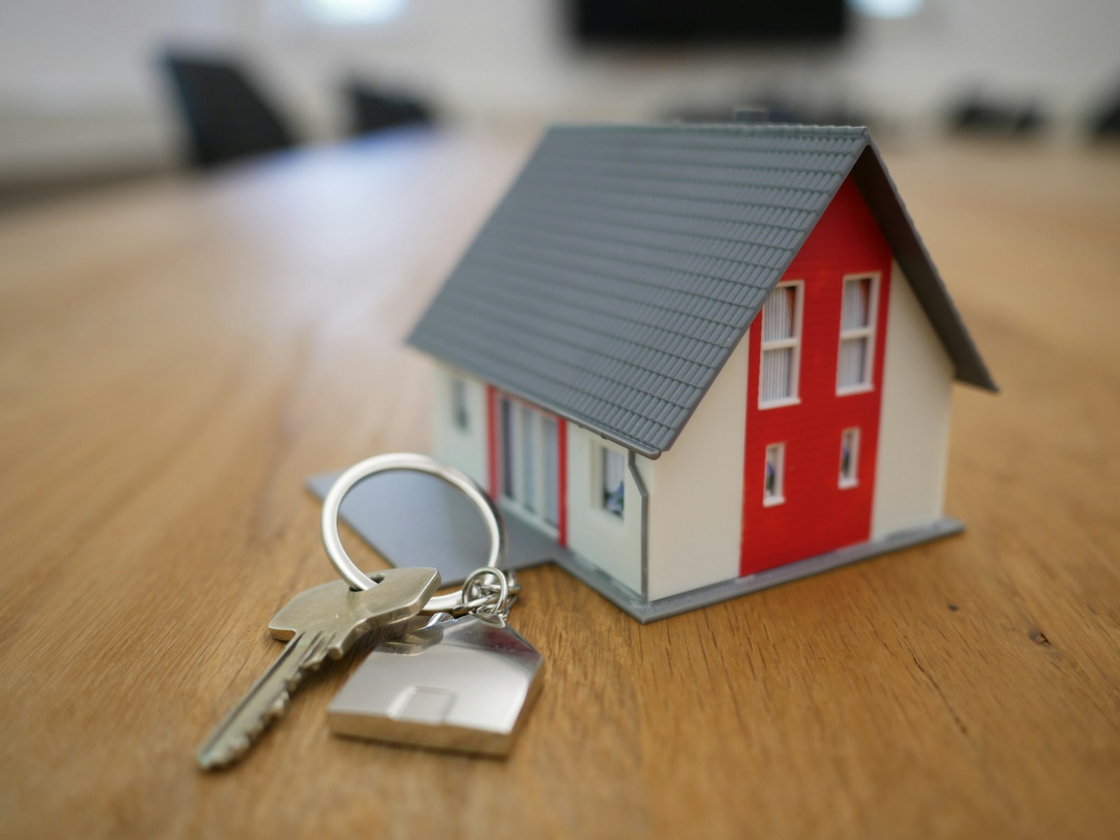 House keys on a wooden table. The moment the inspection report lands in your inbox is the moment you need to know what matters.